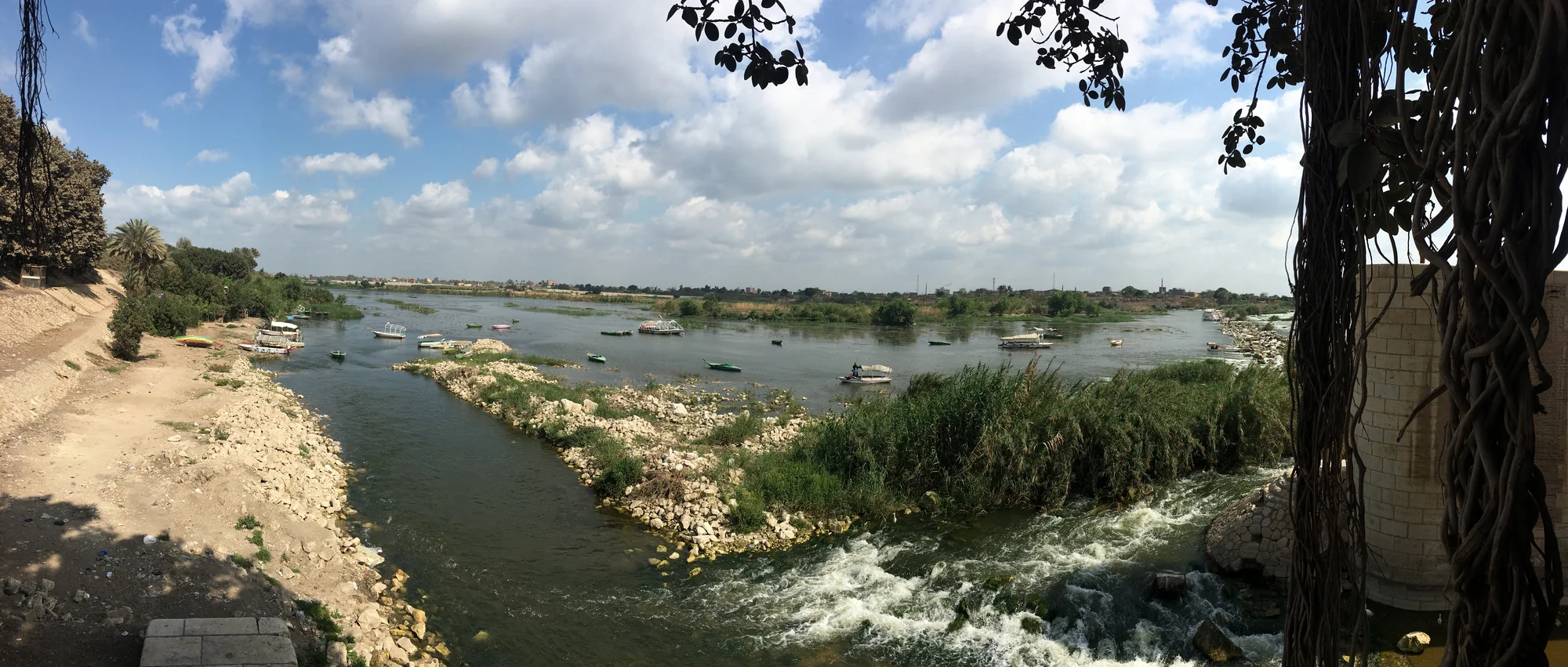 Boats, vegetation and water beside the Rosetta Barrage at El Qanater El Khayreya